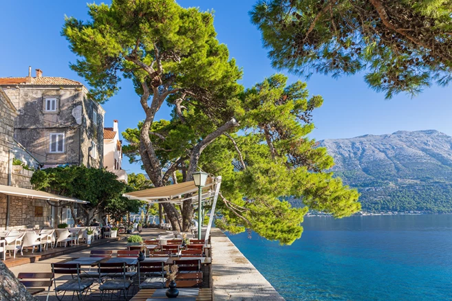 The waterfront of the old town with tables of restaurants on the island of Korcula, Croatia