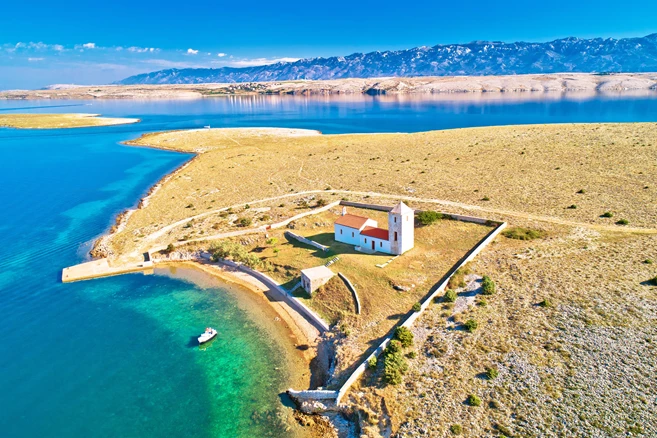 Stone desert island of Zecevo church aerial view, Zadar archipelago of Croatia