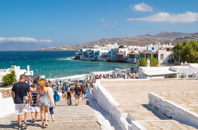 Tourists disembarking their cruise ship and heading towards Mykonos town