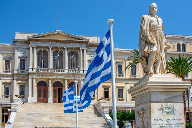 Ermoupoli townhall in Syros island featuring the statue of a fighter of the greek independence war