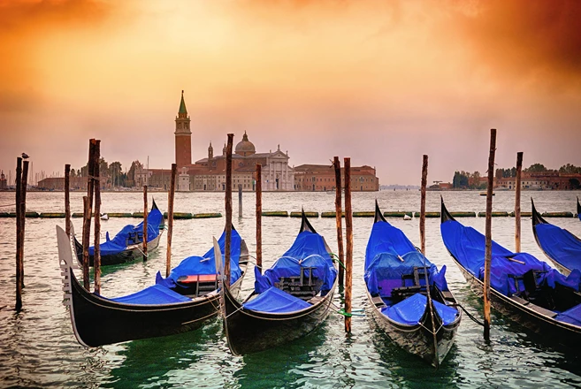 Gondolas moored by Saint Mark square with San Giorgio di Maggiore church